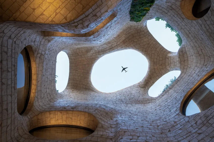 Atrium courtyard ceiling with organic skylights and airplane overhead